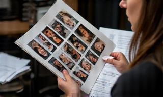 Casting director reviewing headshots of actors